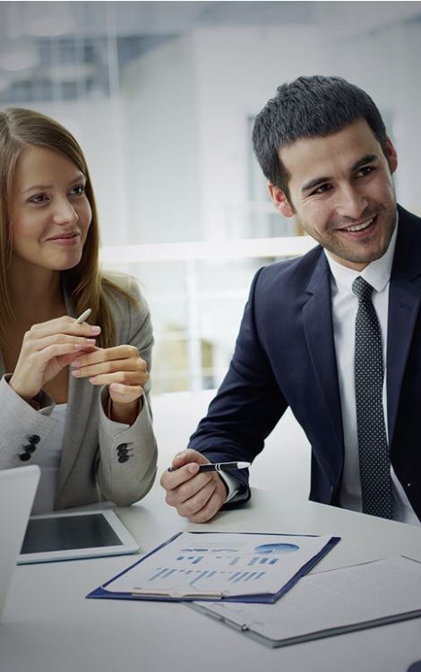 Two people sat at desk