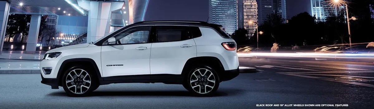 White New Jeep Compass parked at night