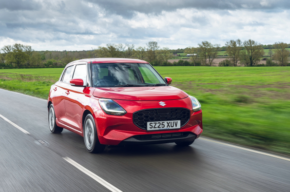 red suzuki swift on a motorway