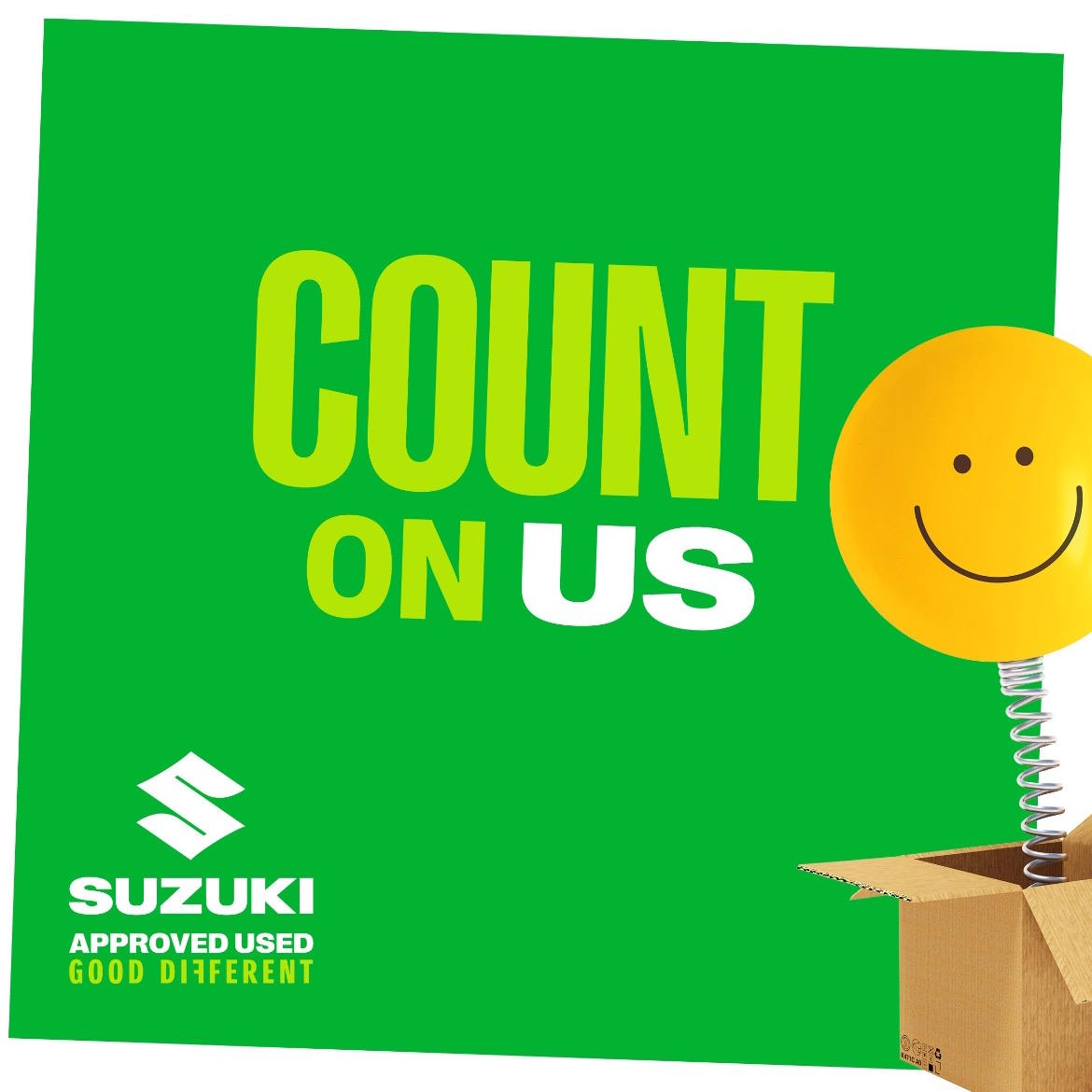Suzuki Approved Used promotional graphic featuring 'Count On Us' messaging with a cheerful yellow smiley face spring toy and the Suzuki Good Different branding.
