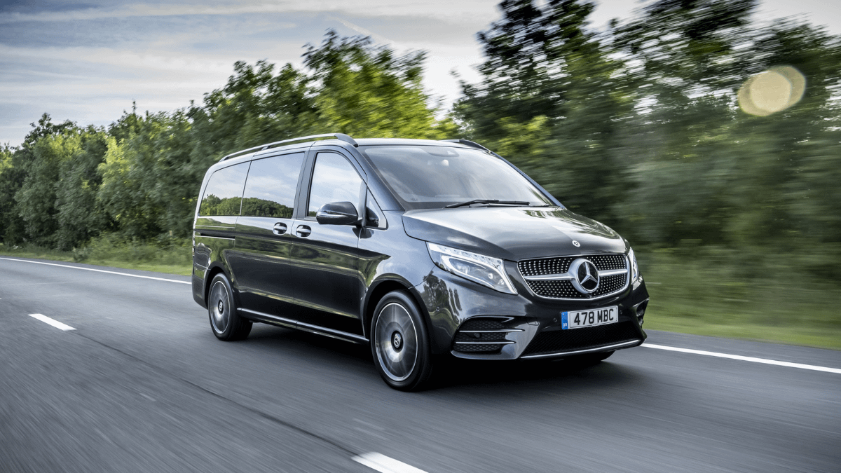 Mercedes-Benz V-Class driving on an open road, highlighting one of the best luxury MPVs for chauffeur work and executive travel in 2026.