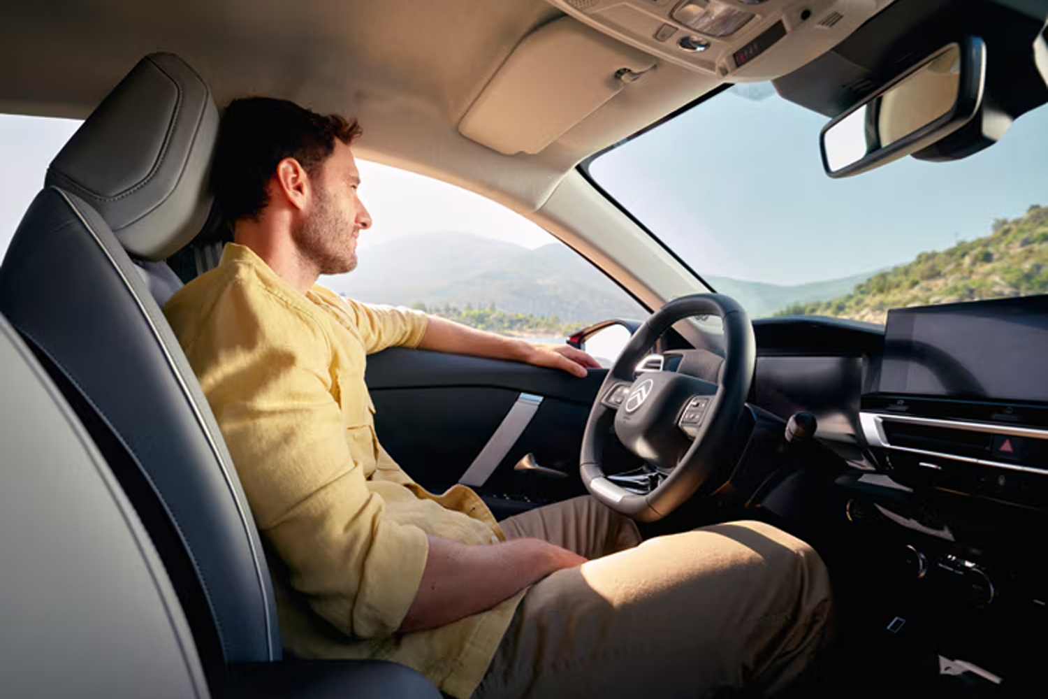 interior shot of a man sat in the driving seat of a New C4