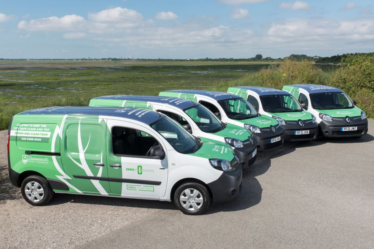 Green vans parked in semicircle