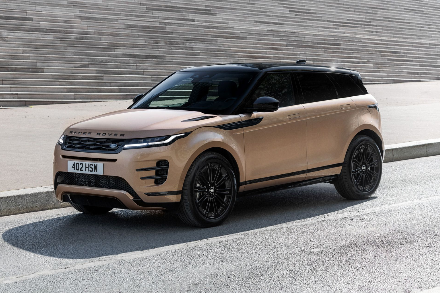 Bronze Range Rover Evoque parked beside modern steps.