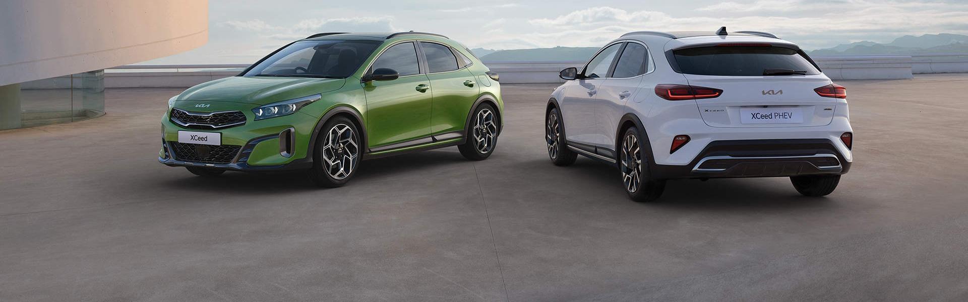 Front view of a green Kia XCeed and a white Kia XCeed PHEV