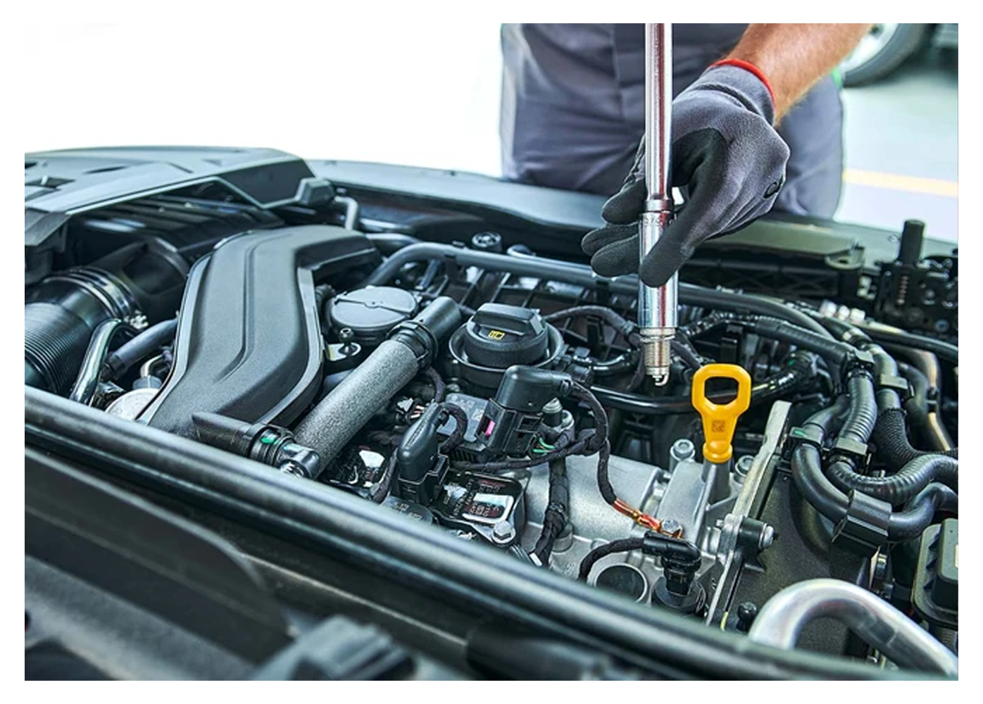 mechanic working under the bonnet of a car