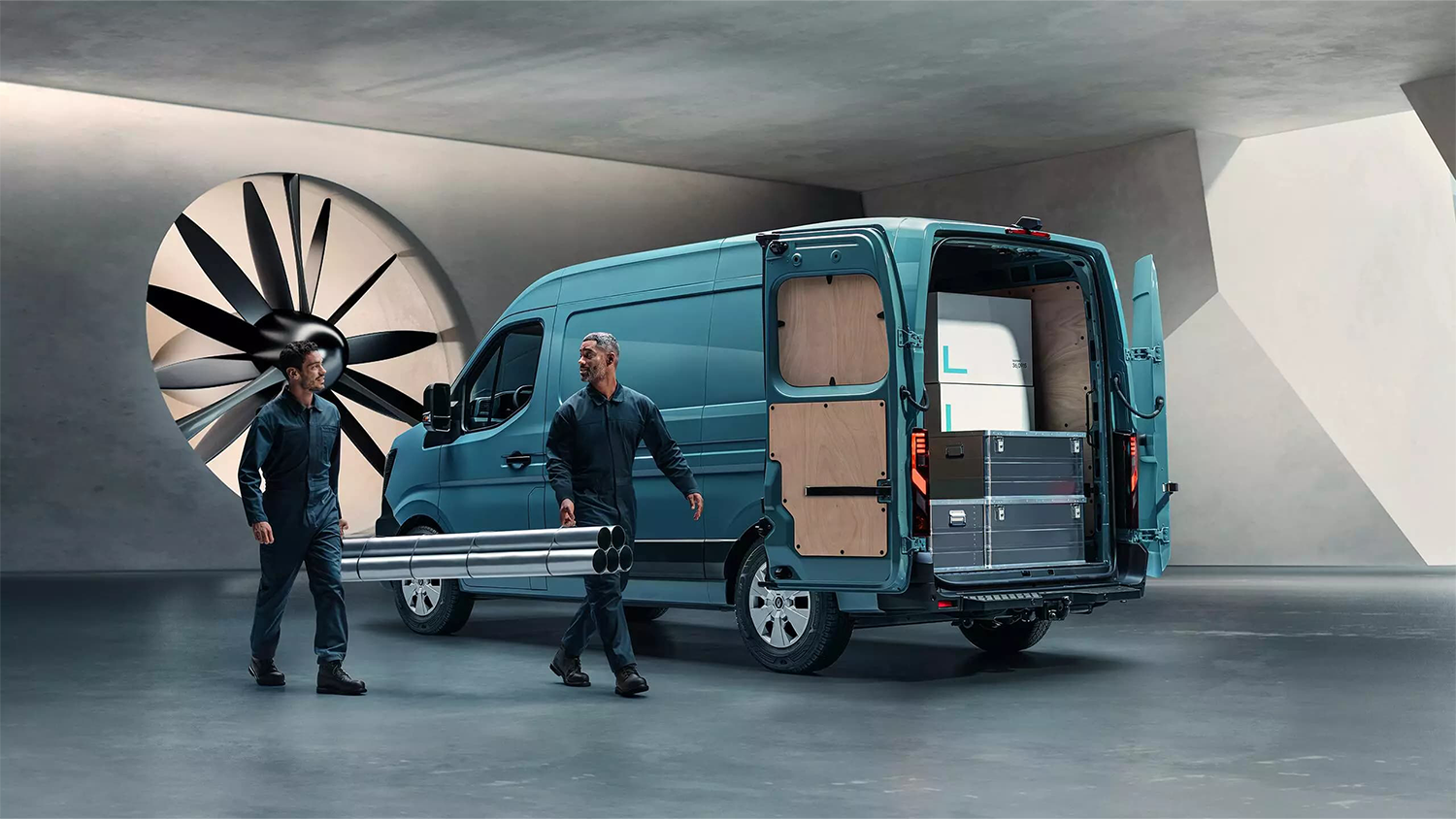 man carrying pipes to load in van