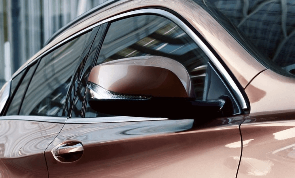 Close up of gold car wing mirror
