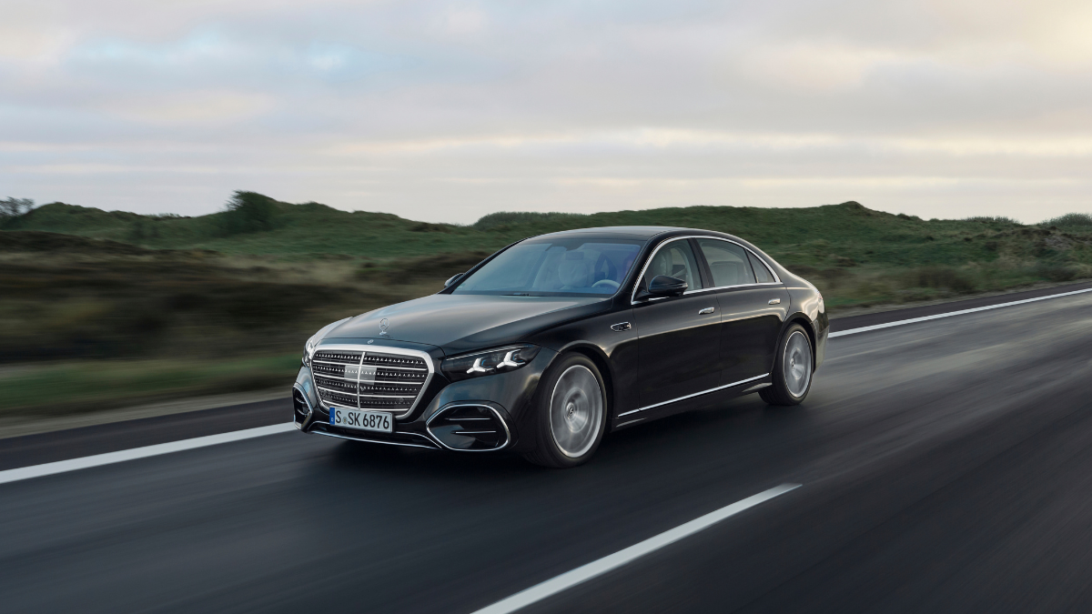 Mercedes-Benz S-Class driving on an open road, showcasing a luxury executive saloon popular for chauffeur services and premium business travel.