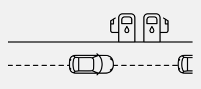 Cars on road driving past petrol refuel station