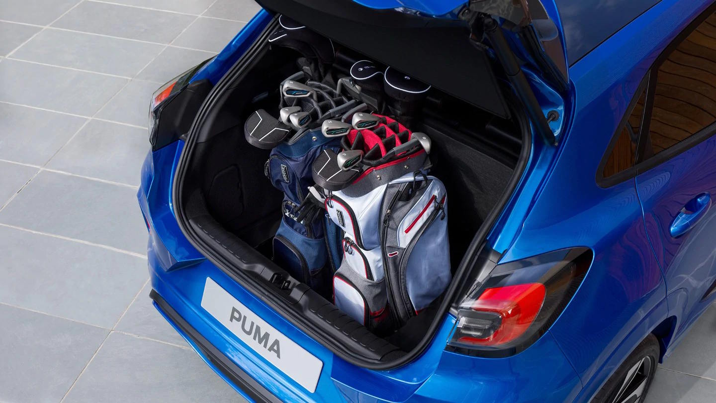 trunk of a blue puma containing golf tools