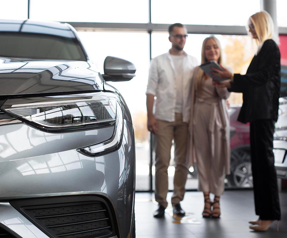 car dealer attending to customers