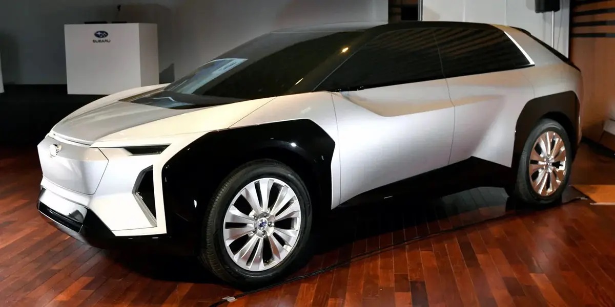 Silver Subaru EV side view in showroom