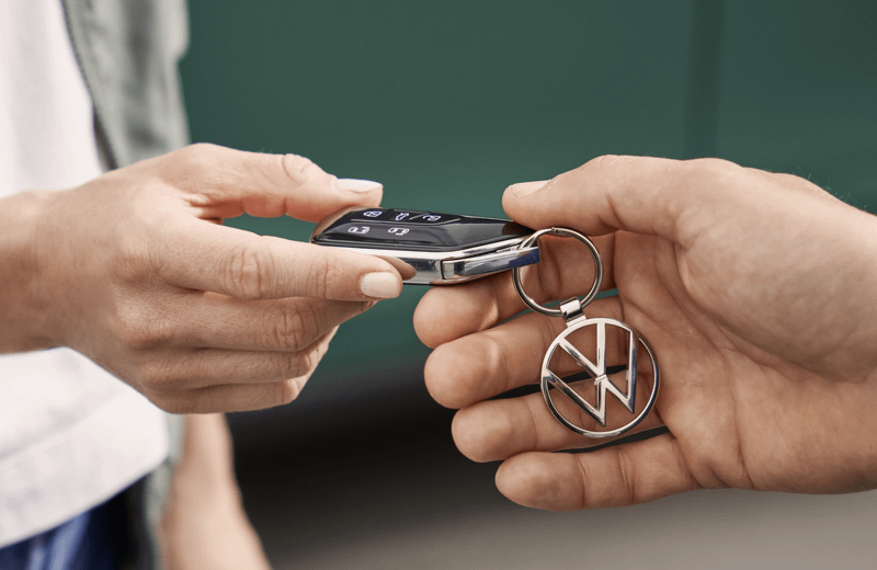 Hands exchanging Volkswagen Key