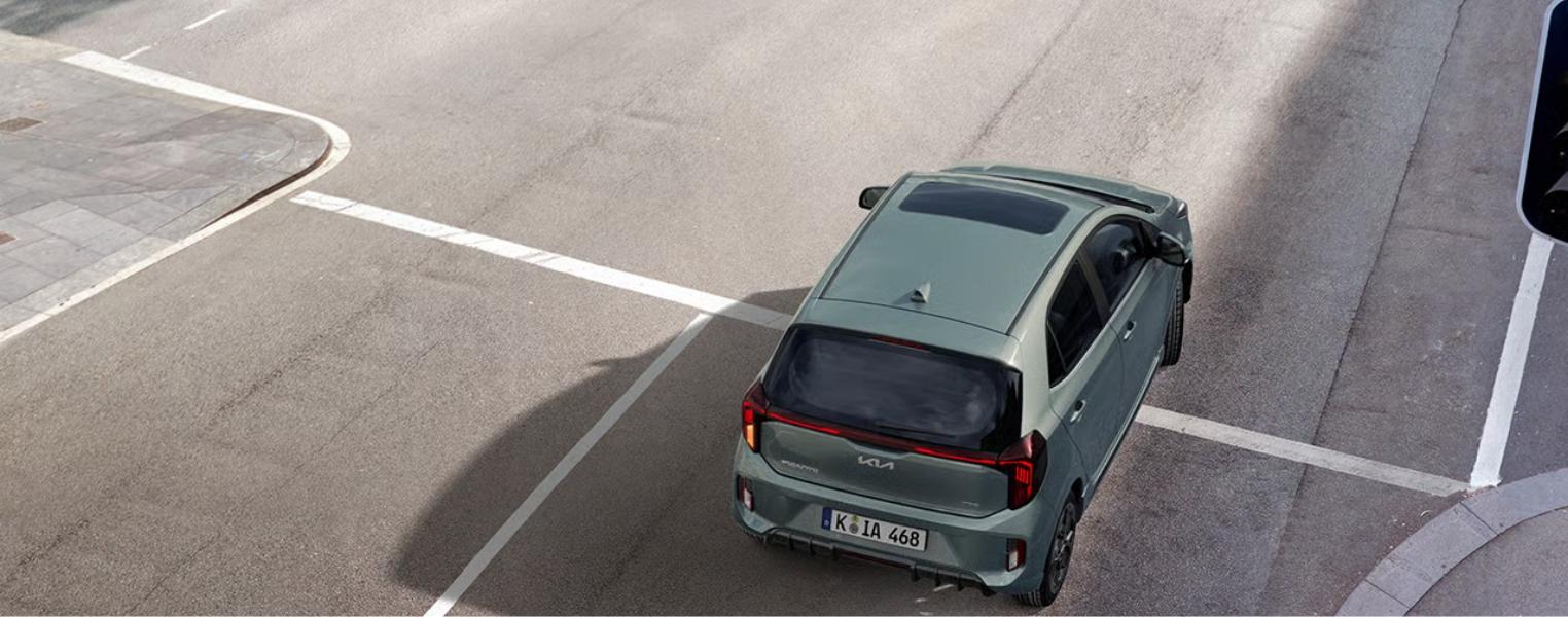 Kia Picanto top view exterior stopped at a traffic signal.