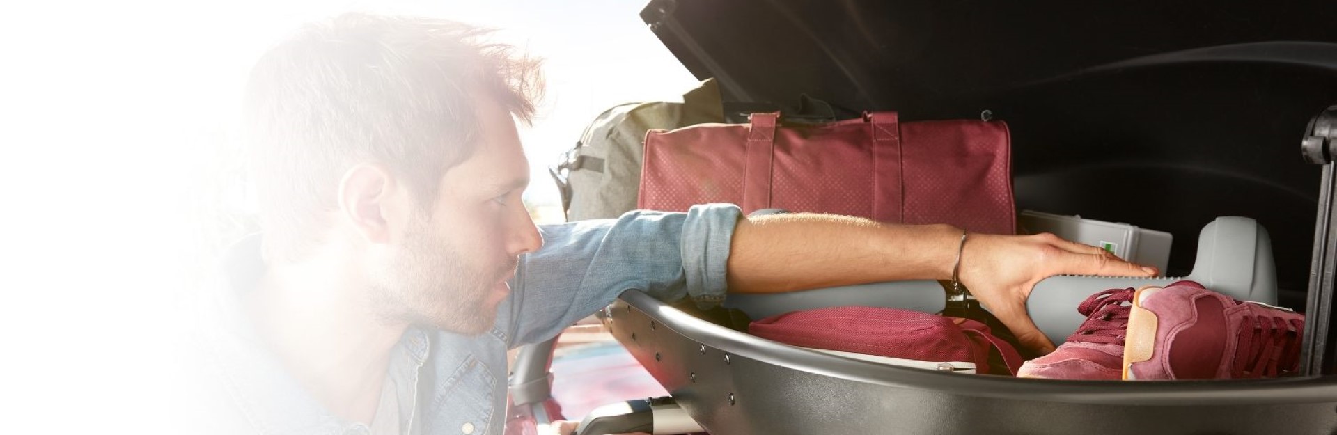 Man packing his Nissan car trunk