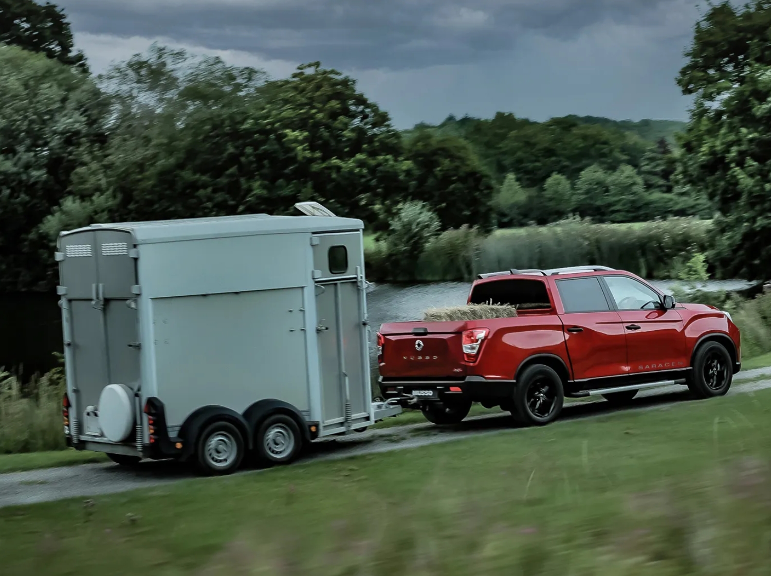 KGM Musso driving with a towed trailer