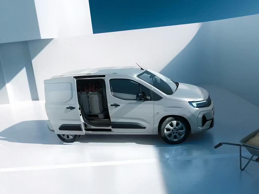 Side profile of a silver Vauxhall Combo Cargo with the sliding side door open, showcasing easy loading access.