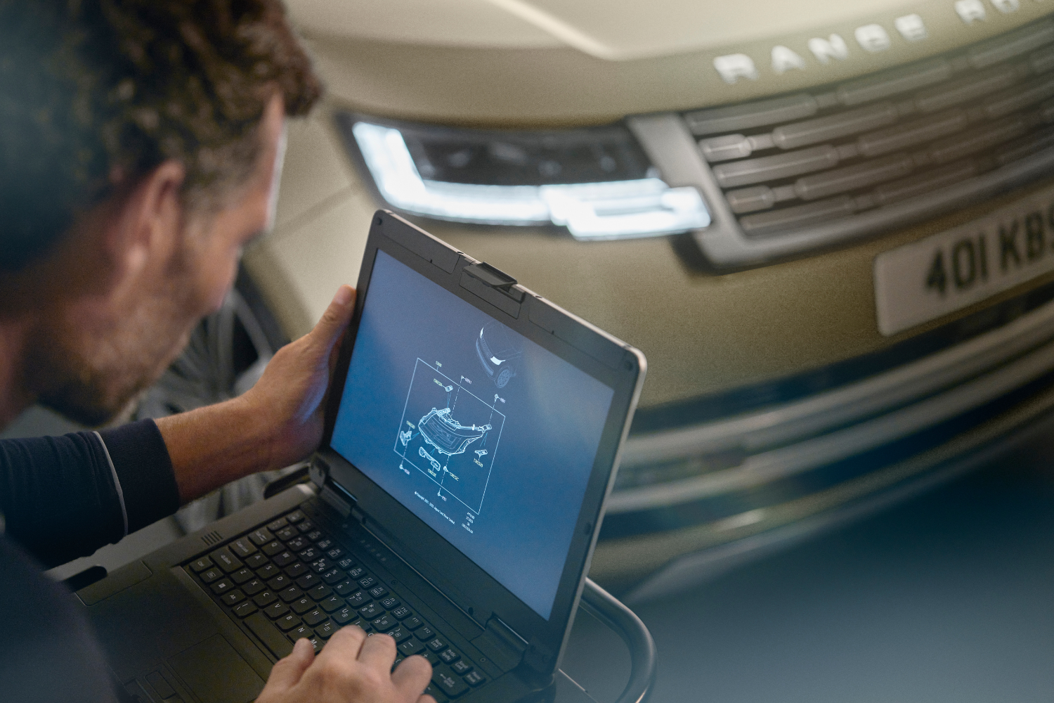 Technician performing diagnostic check on Range Rover.