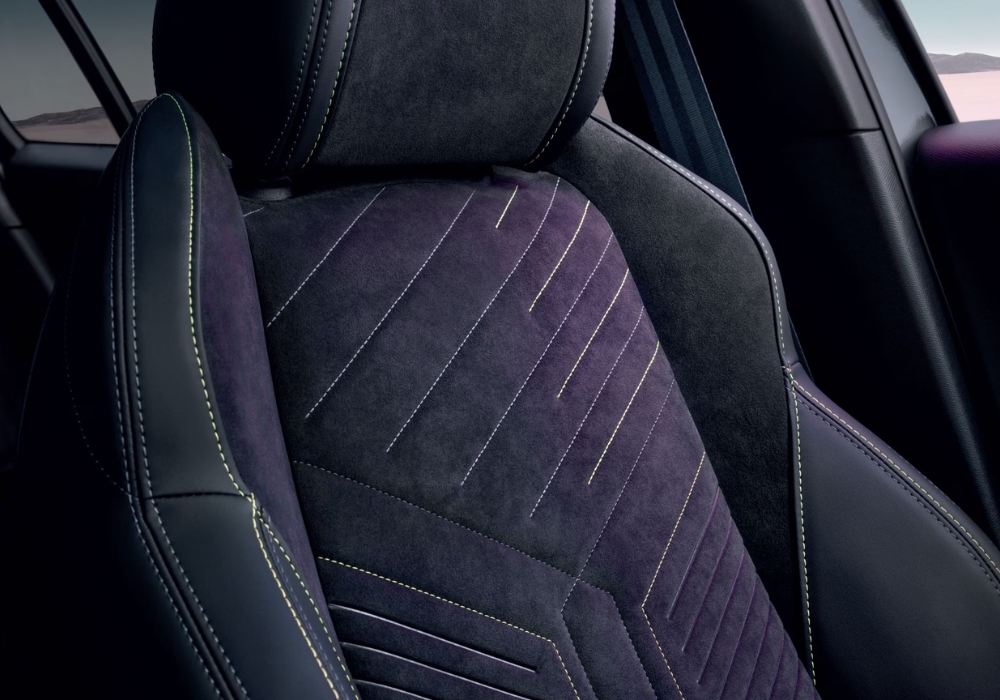 Peugeot 2008 front seat detail with fabric upholstery and contrast stitching.