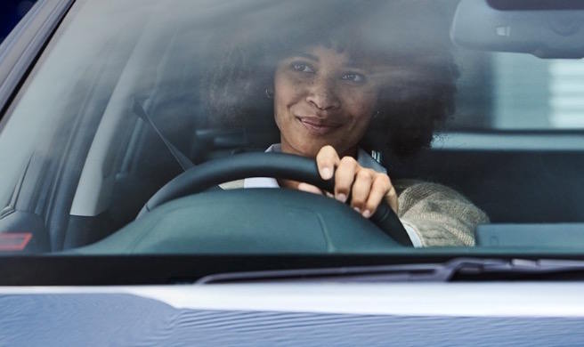 Driver enjoying a comfortable and confident driving experience behind the wheel of a modern vehicle.