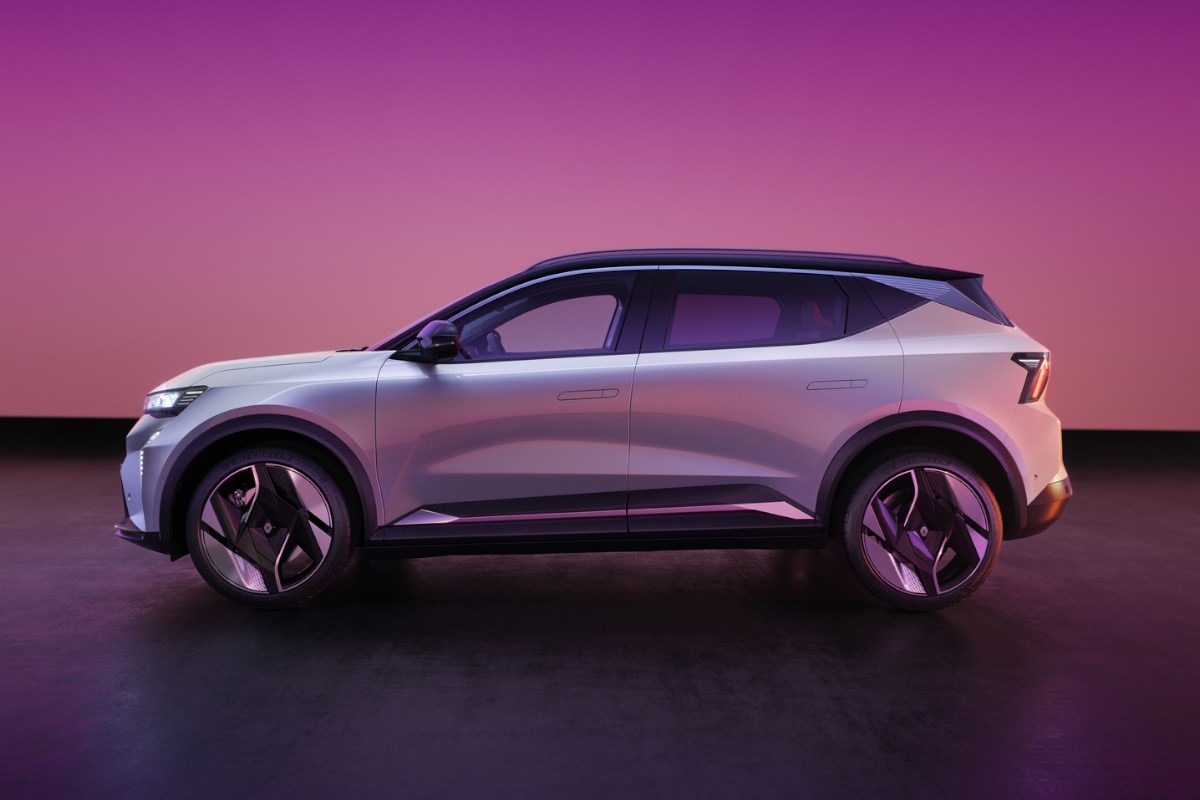 Renault Scenic E-Tech electric SUV in a studio with a purple gradient background, shown in side profile.