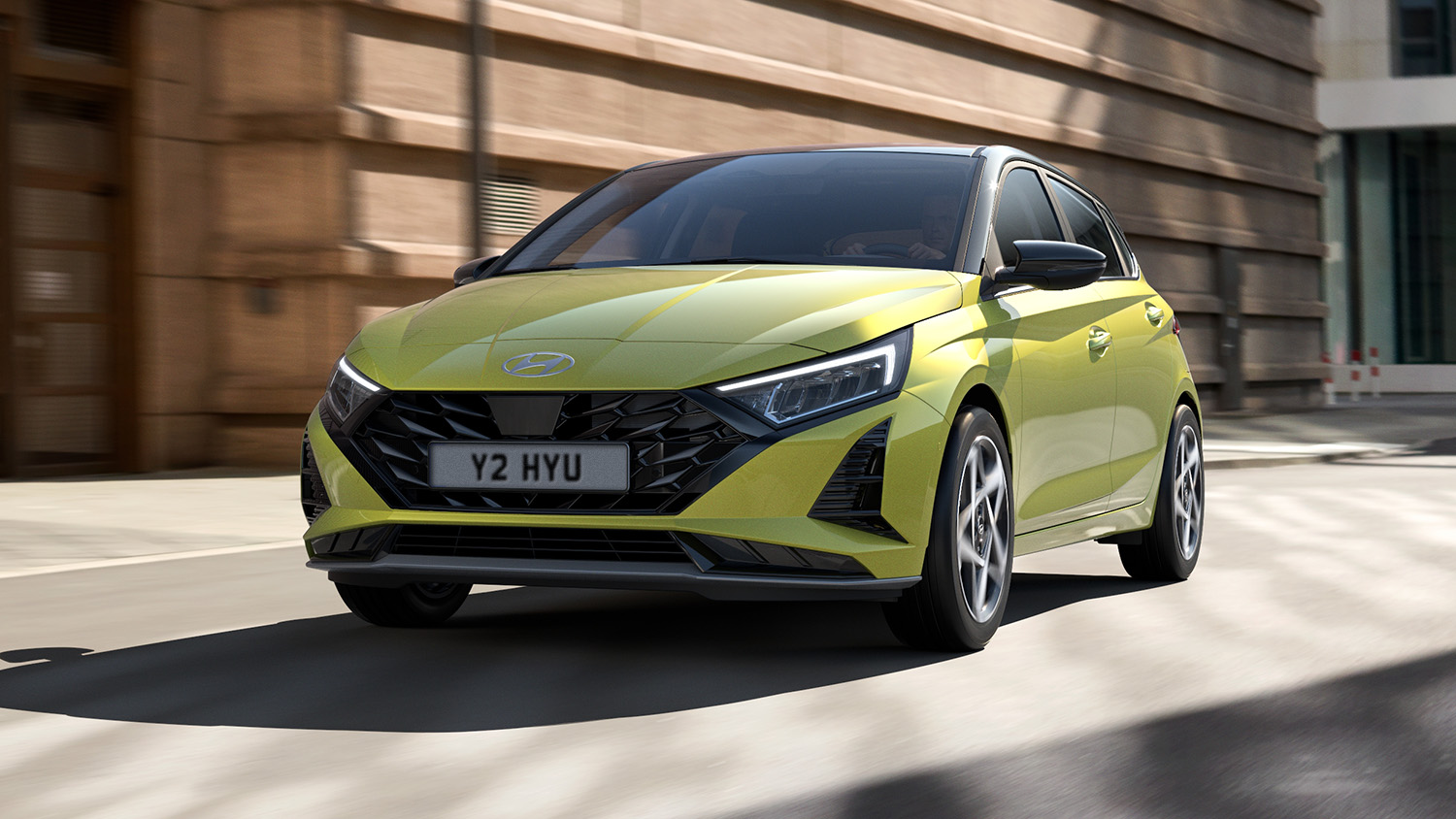 Yellow Hyundai i20 with black roof and features side on