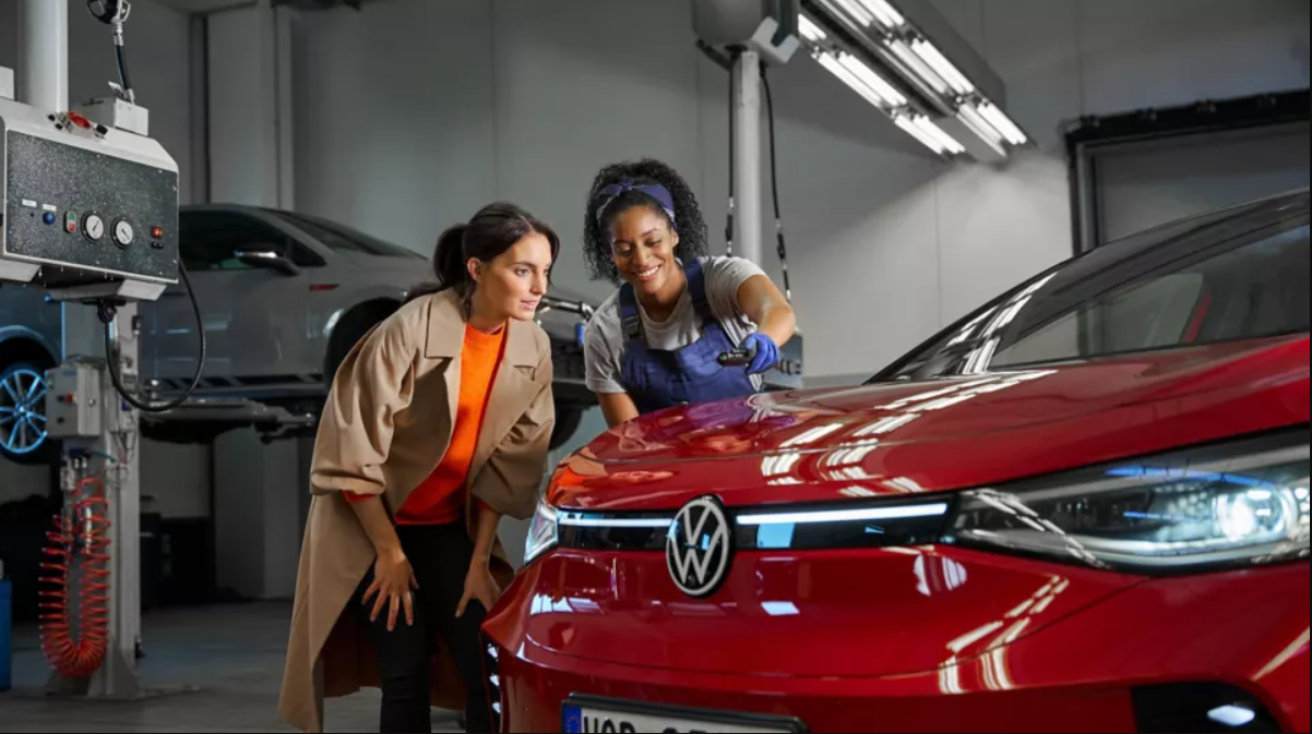 VW mechanic showing customer VW Bonnet