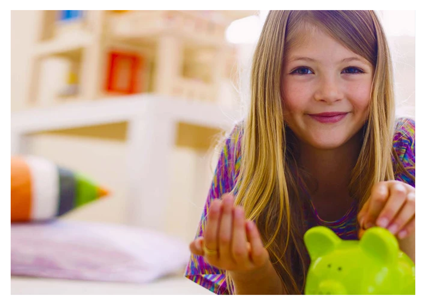 girl saving money in her piggy bank