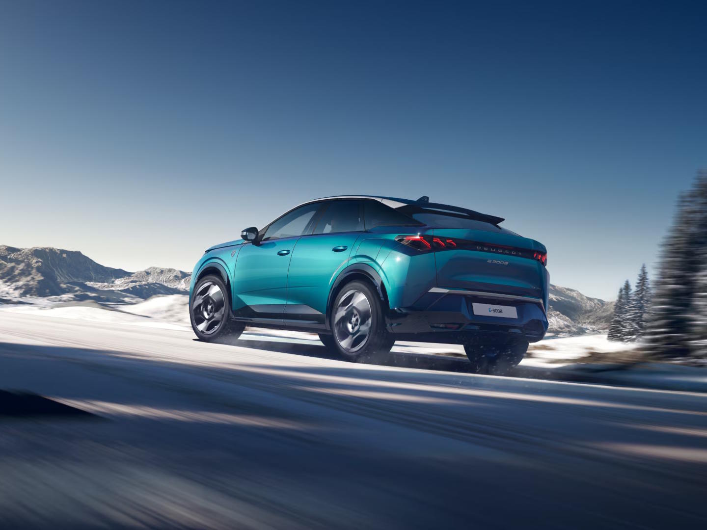 Rear three-quarter view of the Peugeot E-3008 demonstrating its sleek fastback SUV silhouette and dynamic design.
