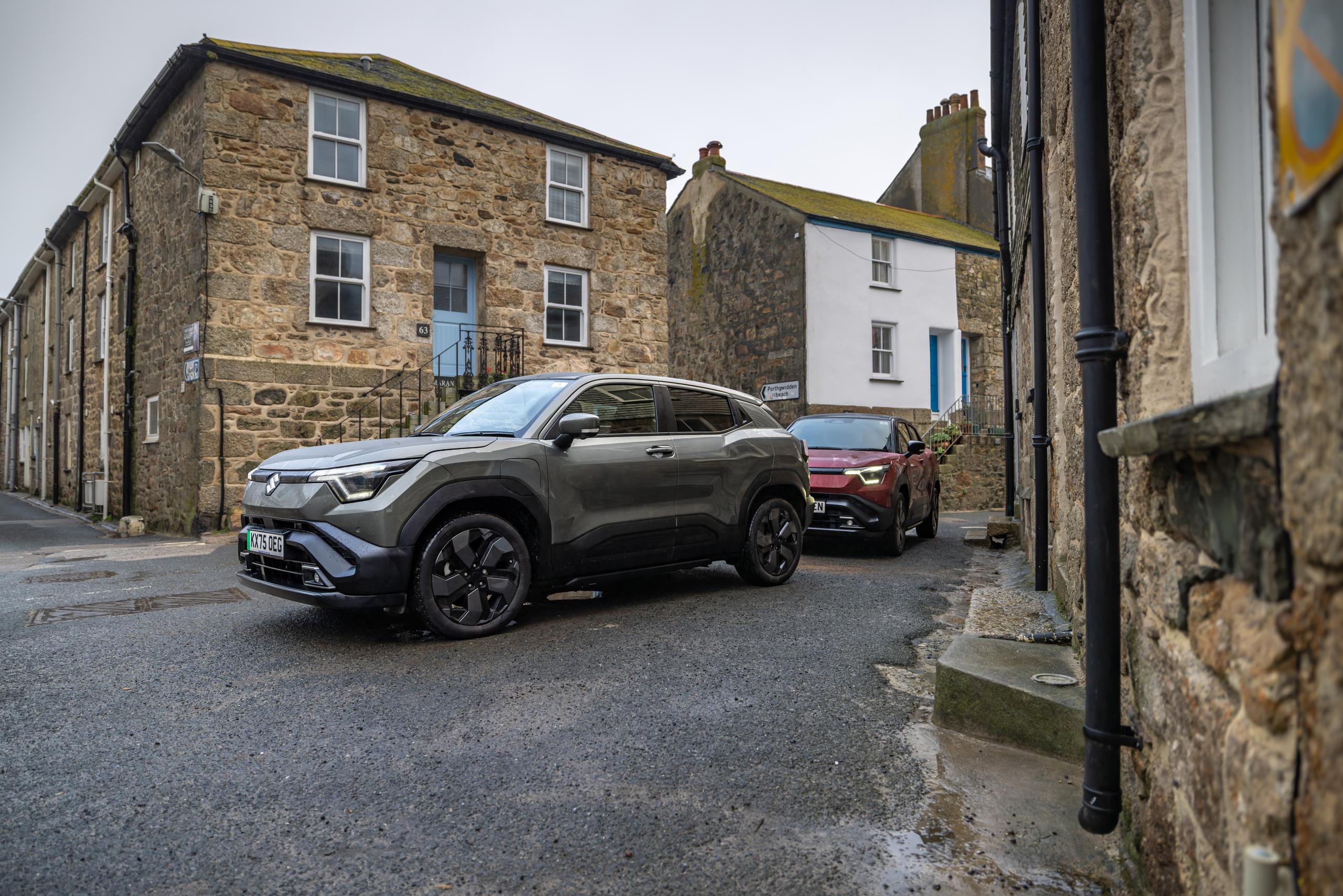 Two Suzuki e-vitara going through twon