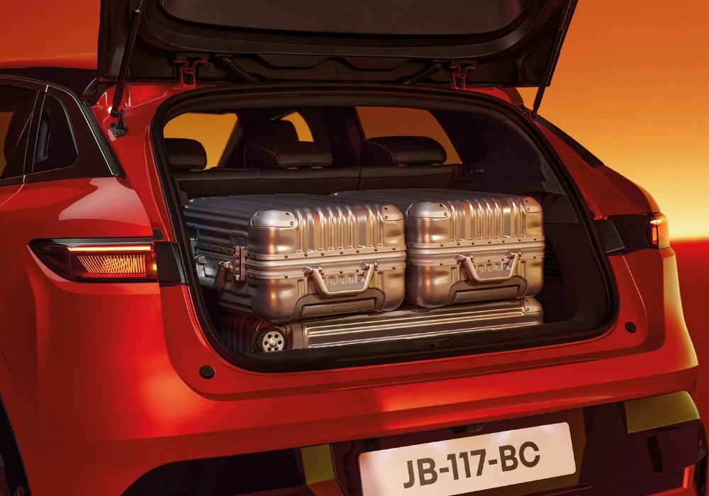 Renault Megane E-Tech boot space showing luggage capacity with suitcases.