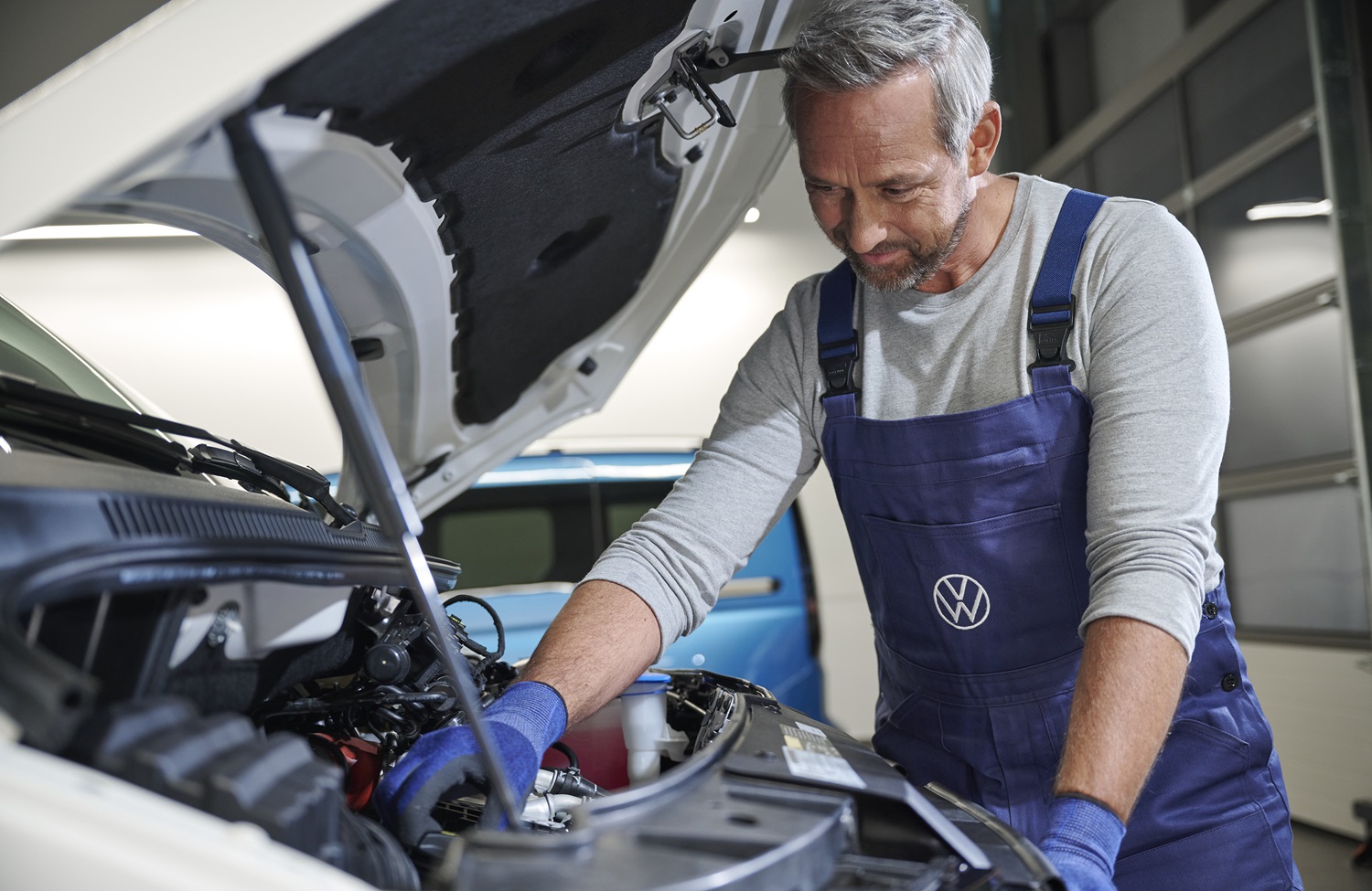 Volkswagen Mechanic Inspecting VW Van