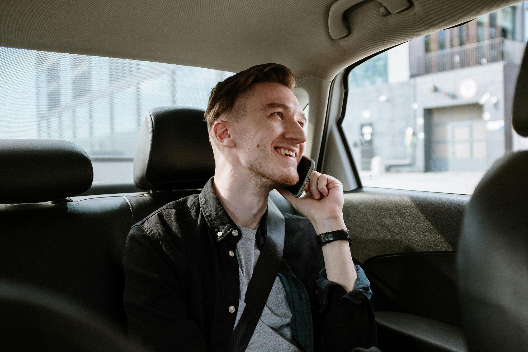 man on the phone in a car