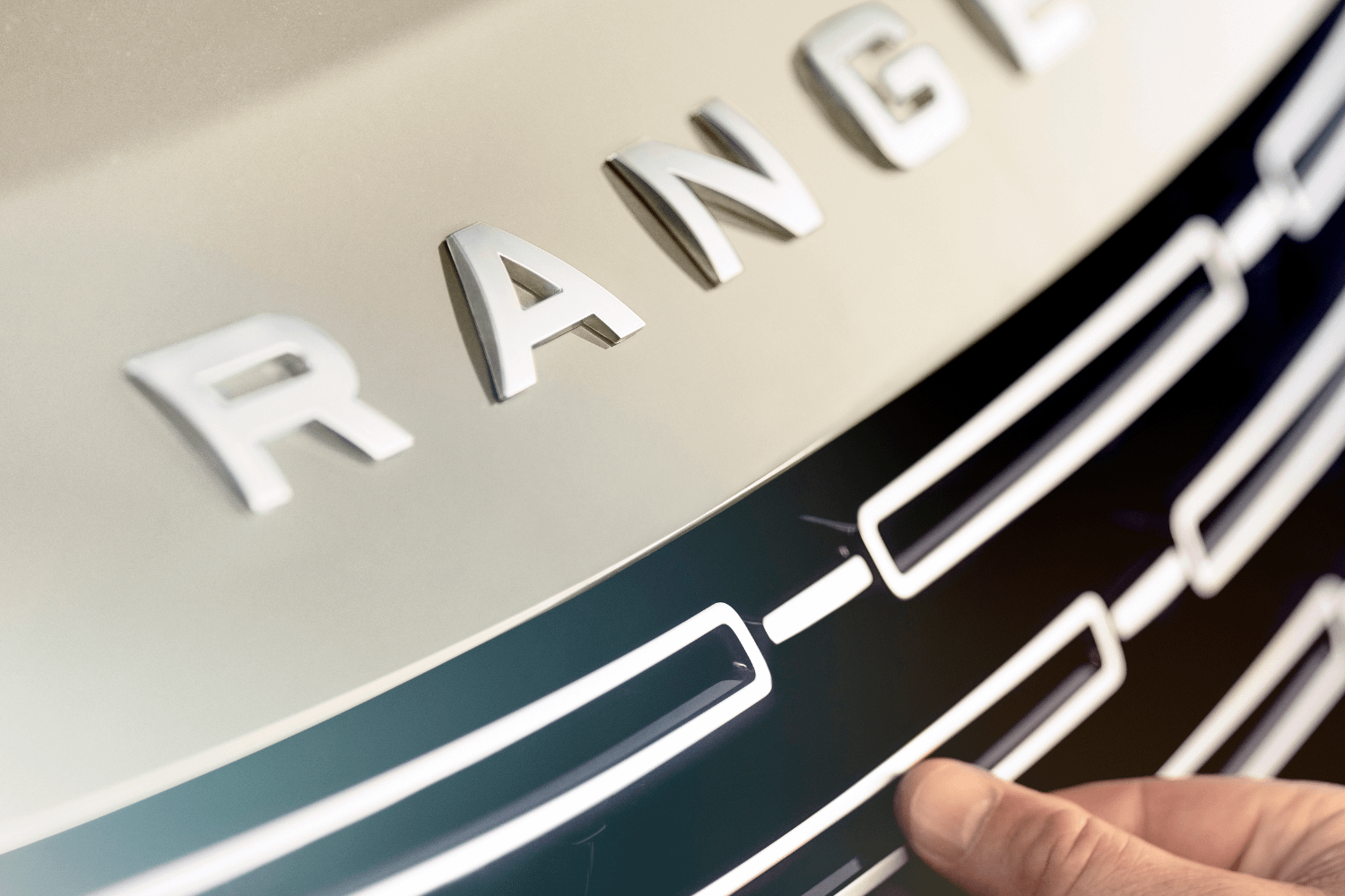 Range Rover front grille design with signature branding in detailed view.