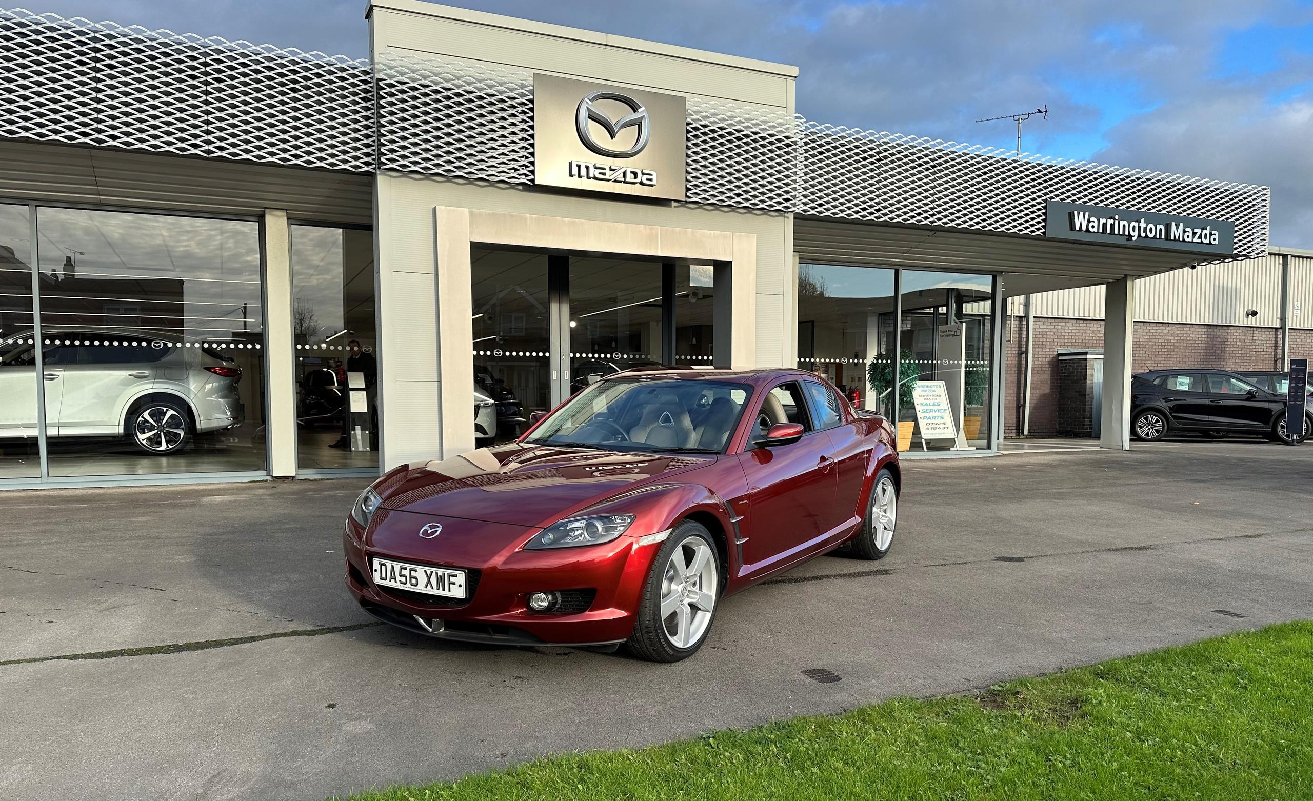 burgundy Mazda outside of showroom