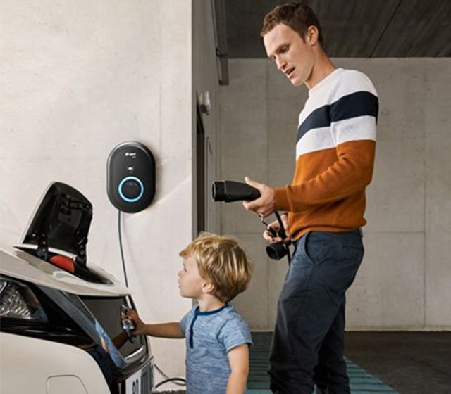 Dad and son electric charging his Nissan