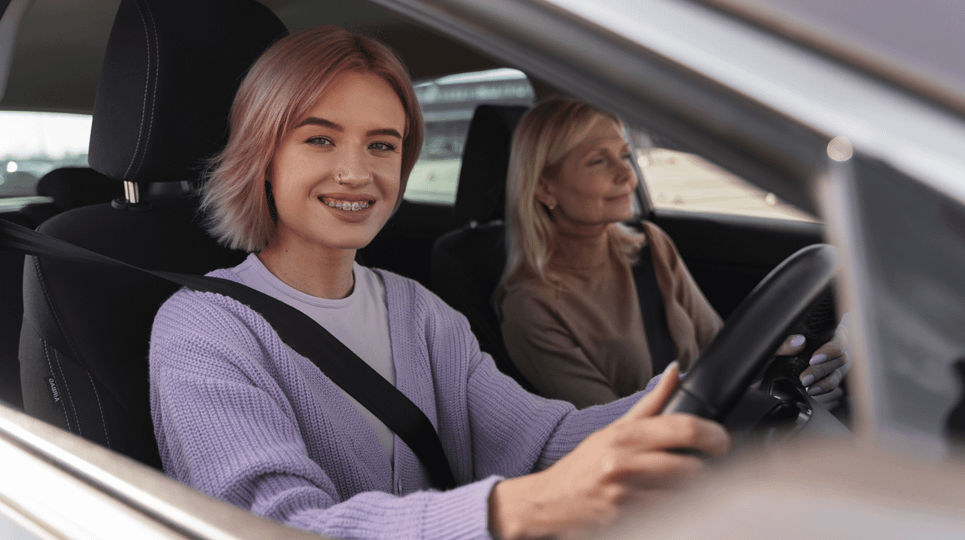 Young driver with an adult in the passenger seat