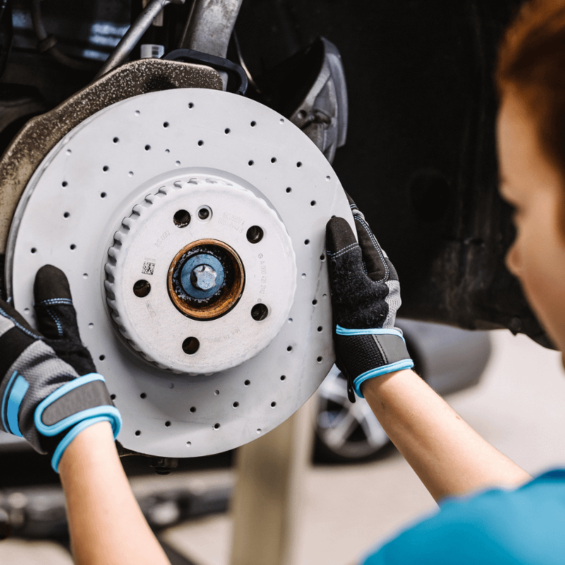 Mechanic Inspecting Brake Disc